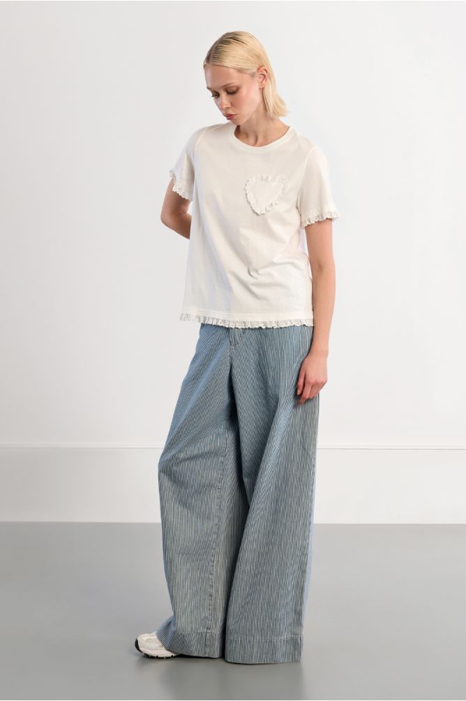 Lili Sidonio cream T-shirt styled with blue wide leg trousers