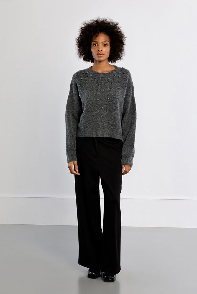 Lili Sidonio grey embellished knit jumper styled with black trousers