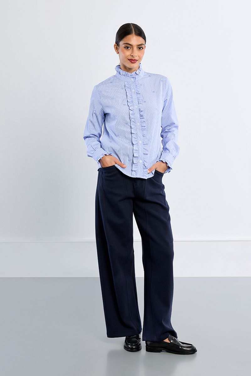 Lili Sidonio blue striped cotton shirt styled with navy trousers – full model view