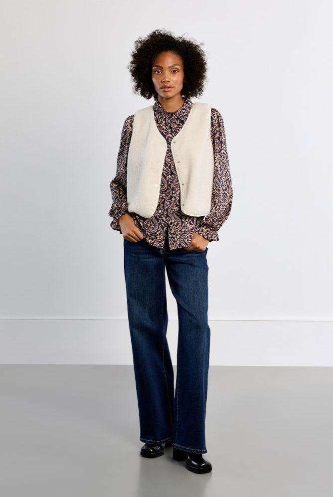 Lili Sidonio women’s cream sleeveless vest styled over printed blouse