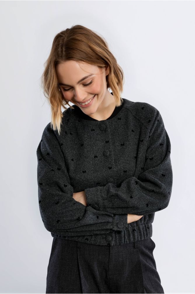 Lili Sidonio grey bomber jacket with black bow details on model