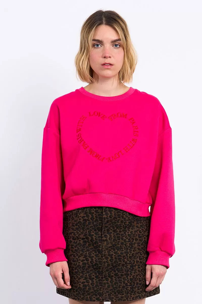 Lili Sidonio pink sweatshirt styled with leopard print mini skirt