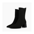 Pair of Lodi Heka black suede ankle boots showing slim ankle and block heels.