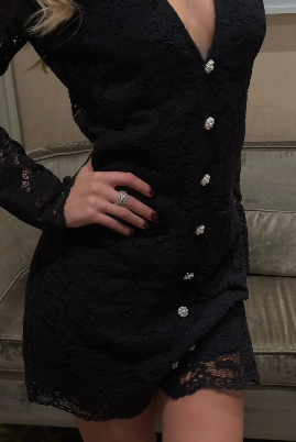 Model wearing Love Lolina black lace dress with deep V and button detail From back