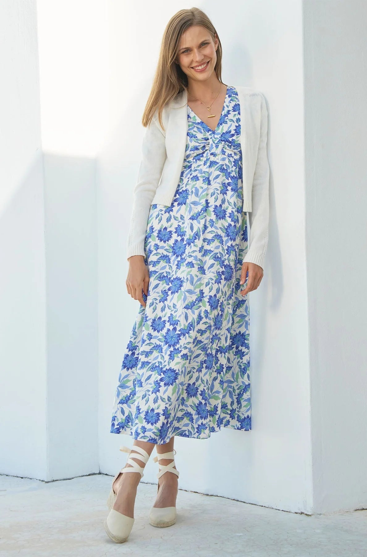 Aspiga cream merino cardigan styled over floral summer dress