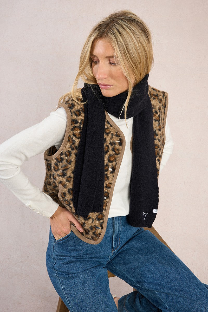 Black Molly Bracken knitted scarf wrapped at the neck over winter layers