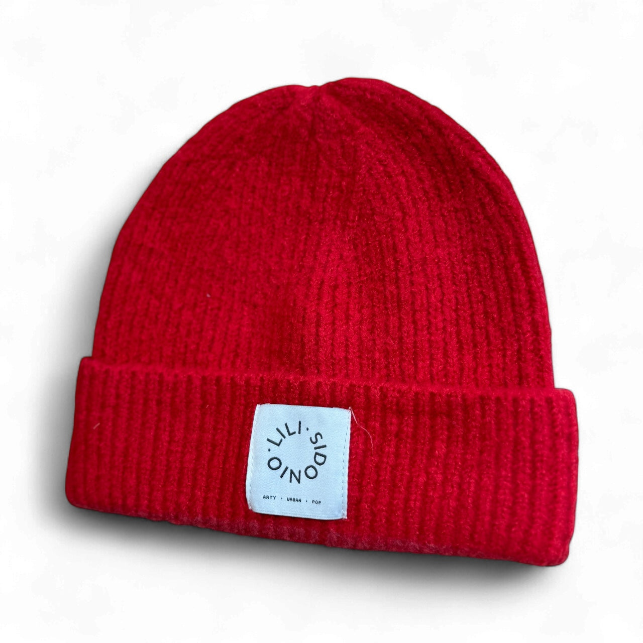 Molly Bracken red ribbed knit beanie hat with white Lili Sidonio logo tag