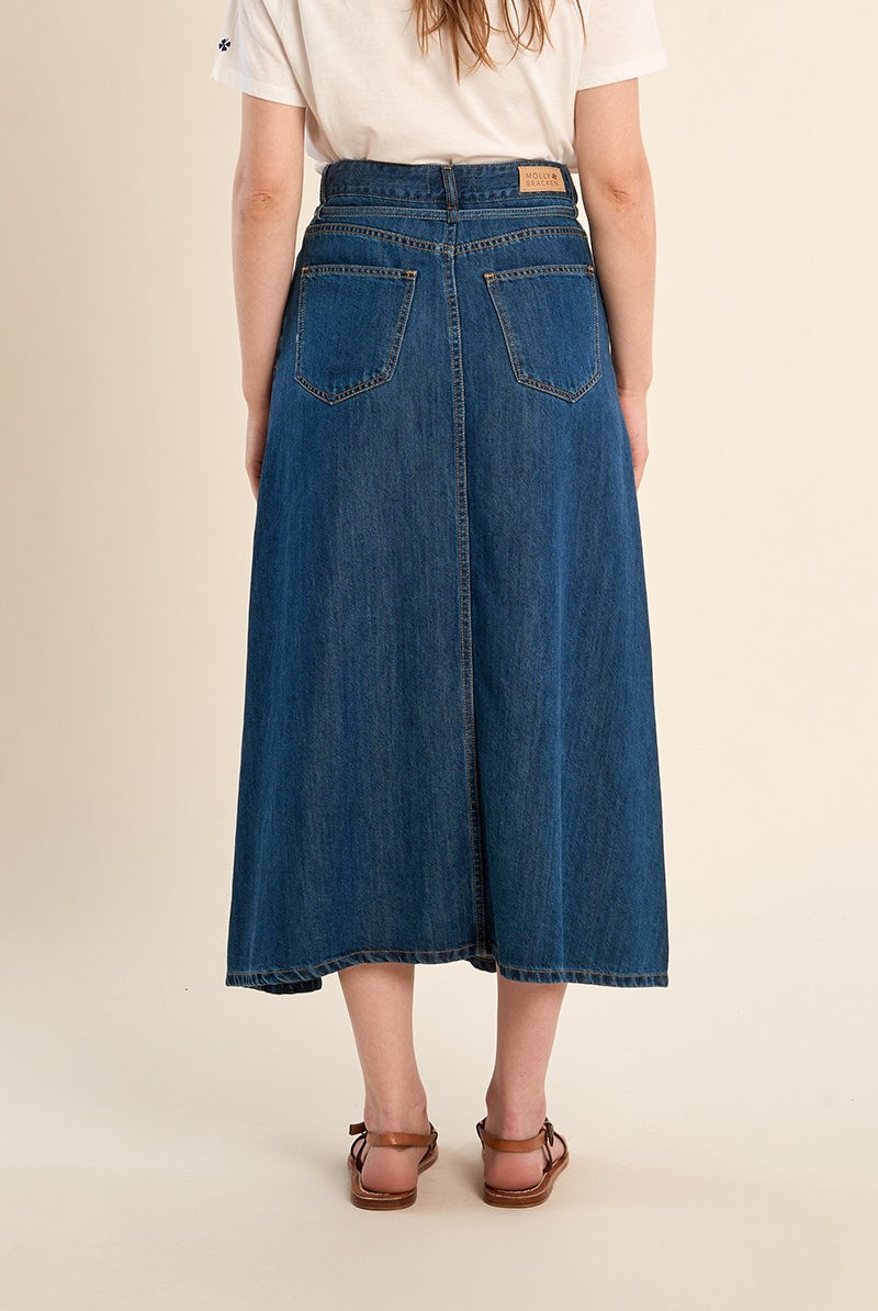Molly Bracken long denim skirt worn with white top side angle