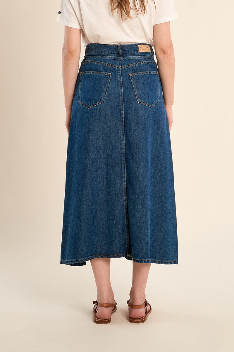 Molly Bracken long denim skirt worn with white top side angle