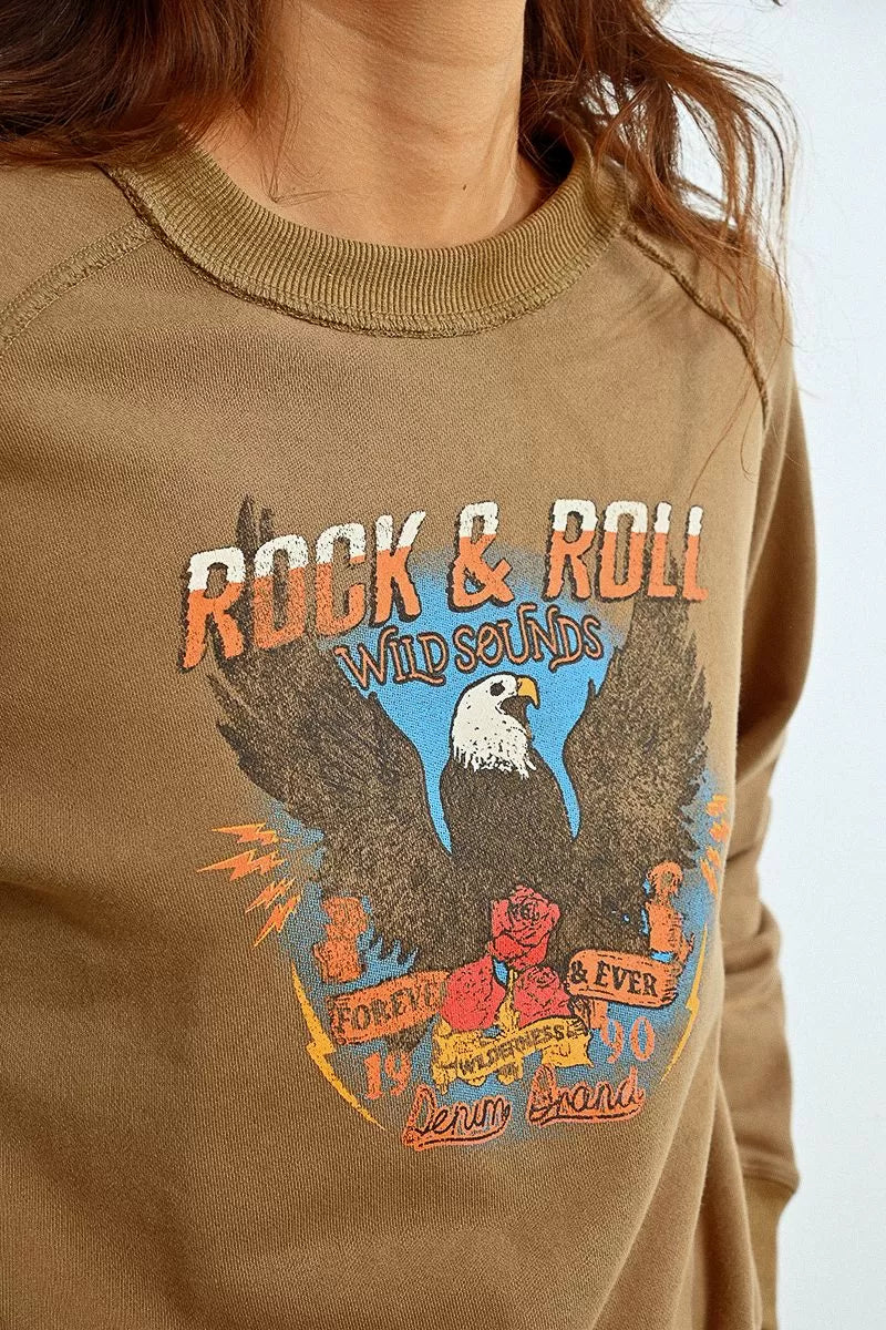 Close-up of Molly Bracken eagle motif on brown sweatshirt