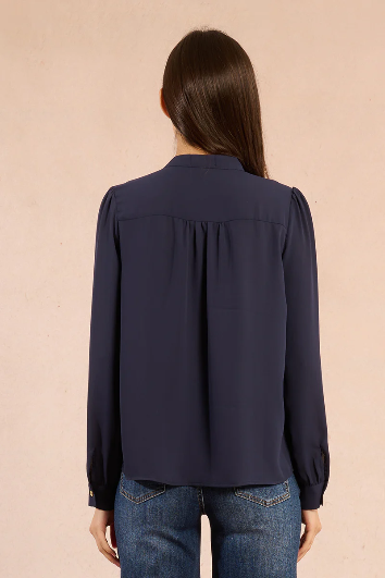Molly Bracken navy ruffle front blouse back view on model