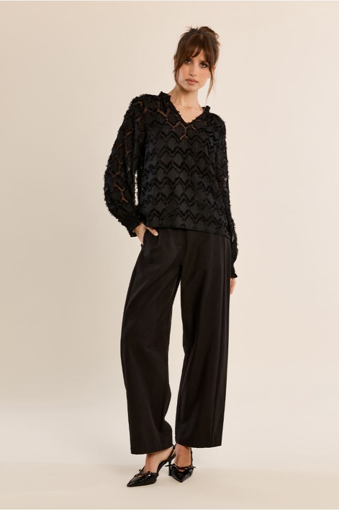 Molly Bracken black long sleeve blouse styled with wide-leg trousers