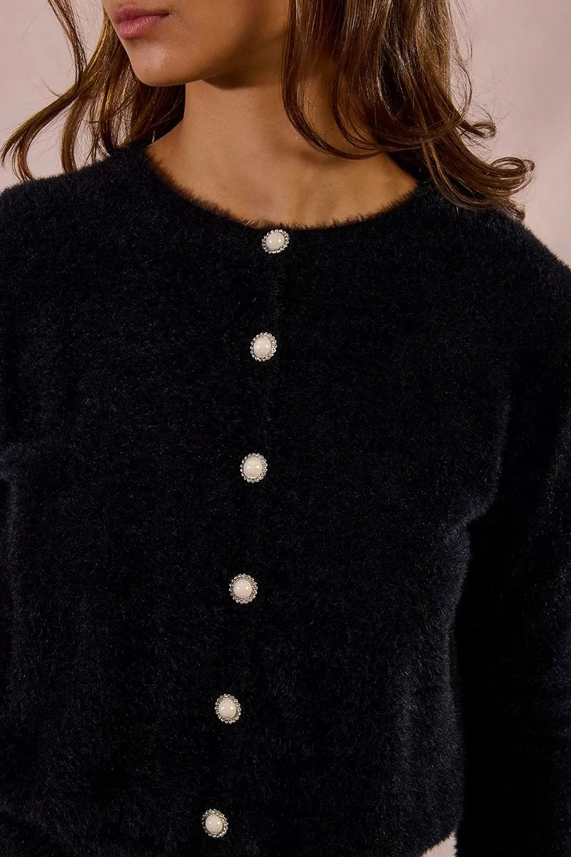 Close up of sparkle faux pearl buttons on a Molly Bracken fluffy knitted cardigan in black