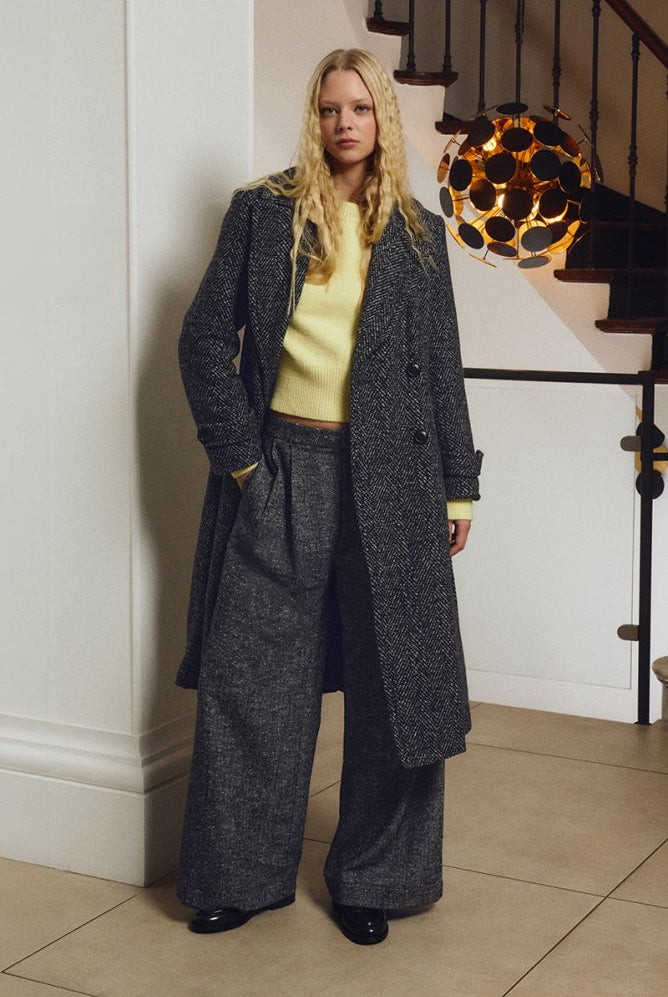 Molly Bracken yellow jumper styled under charcoal herringbone coat