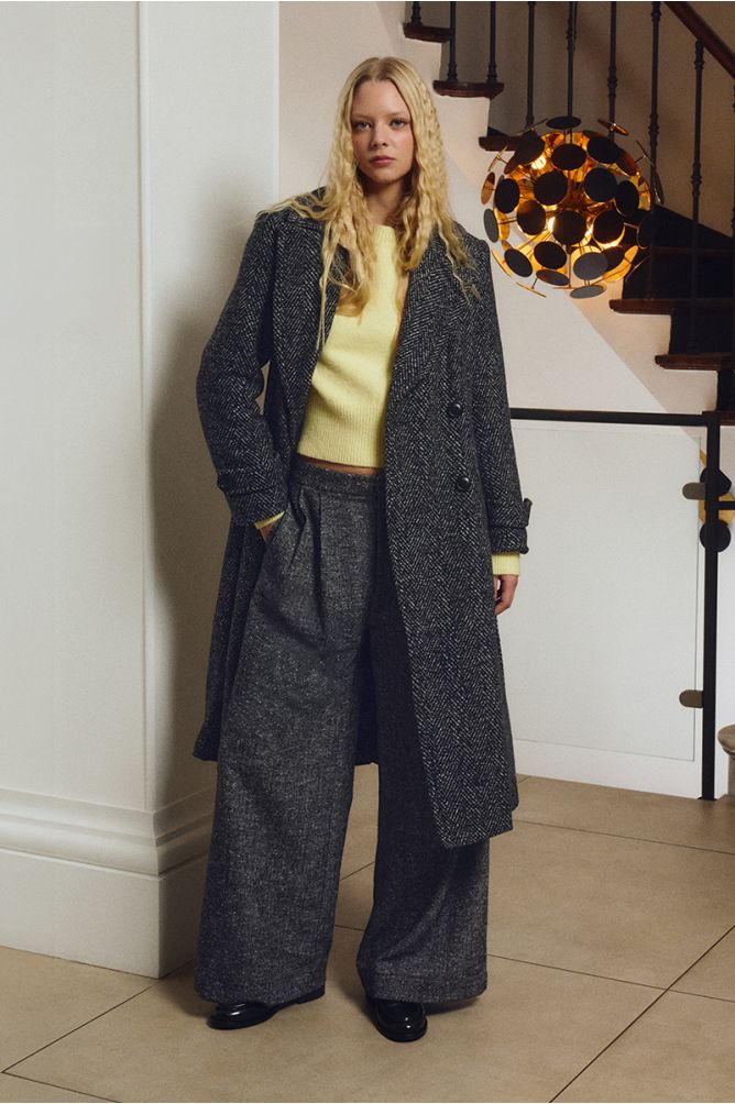 Molly Bracken yellow jumper styled under charcoal herringbone coat