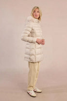 Side view of Molly Bracken long beige puffer jacket with zipped pockets