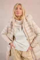 Molly Bracken off white puffer jacket styled open with winter knitwear underneath