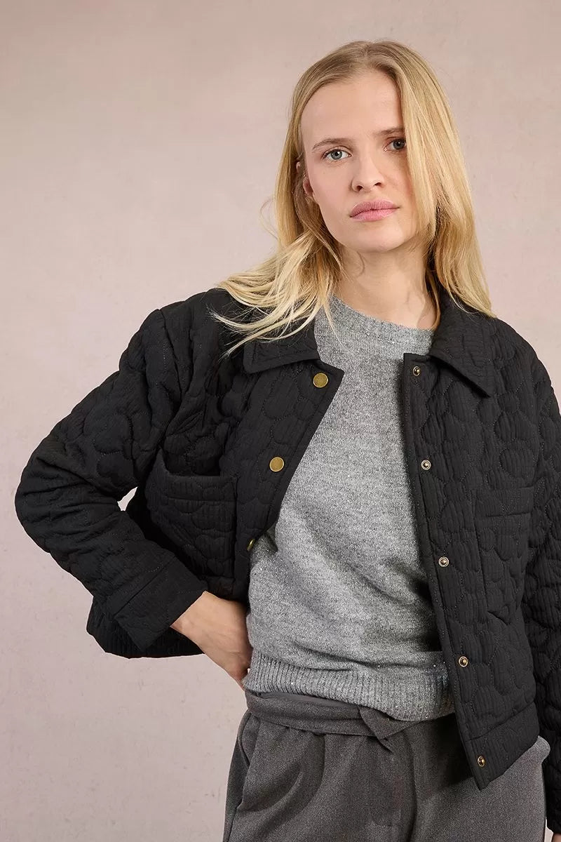 Molly Bracken quilted jacket styled with grey trousers, front angle