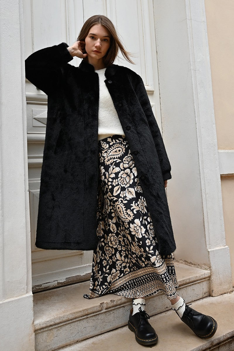 Molly Bracken long boho print skirt in black and beige styled with oversized black coat and boots