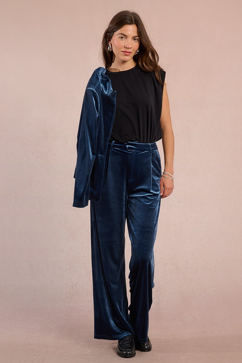 Model wearing Molly Bracken wide leg velvet trousers in sapphire blue, Holding matching suit jacket.