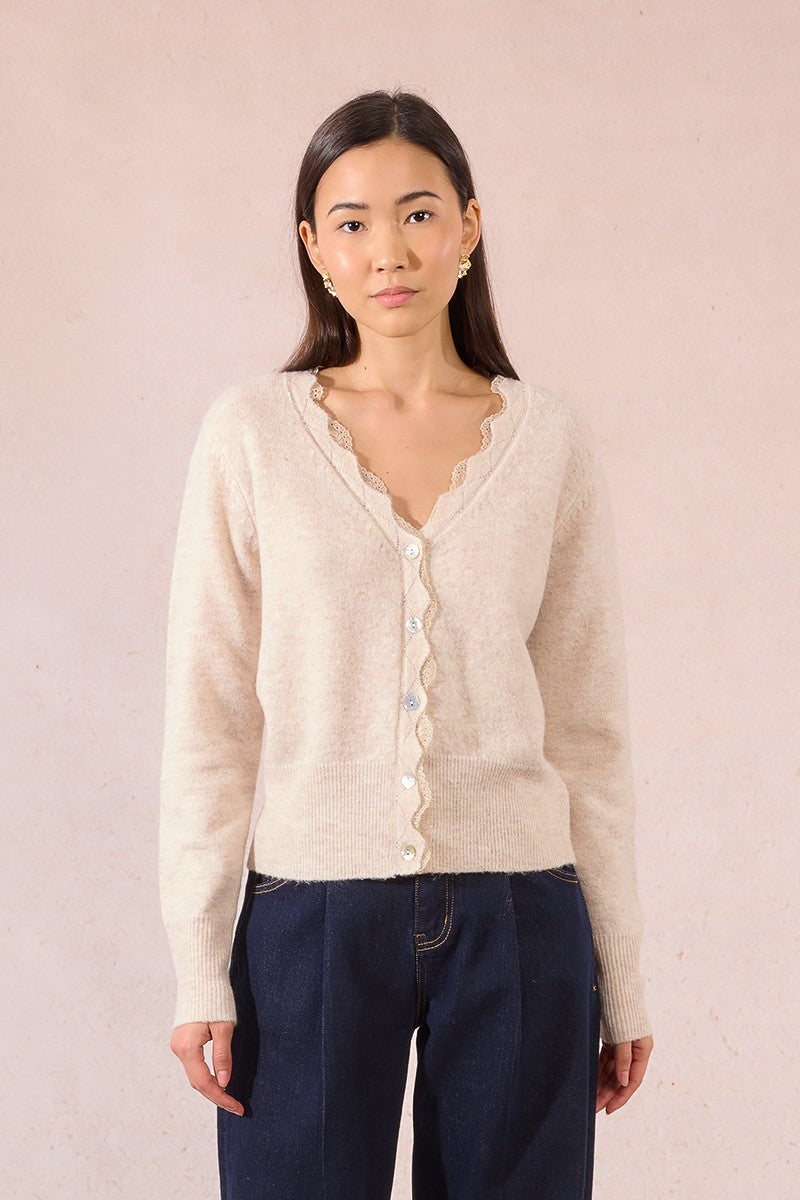 Molly Bracken cream scalloped lace knit cardigan paired with navy trousers.