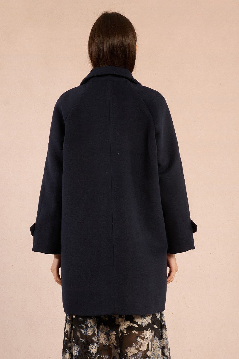 Molly Bracken navy coat with belted cuffs shown from back angle
