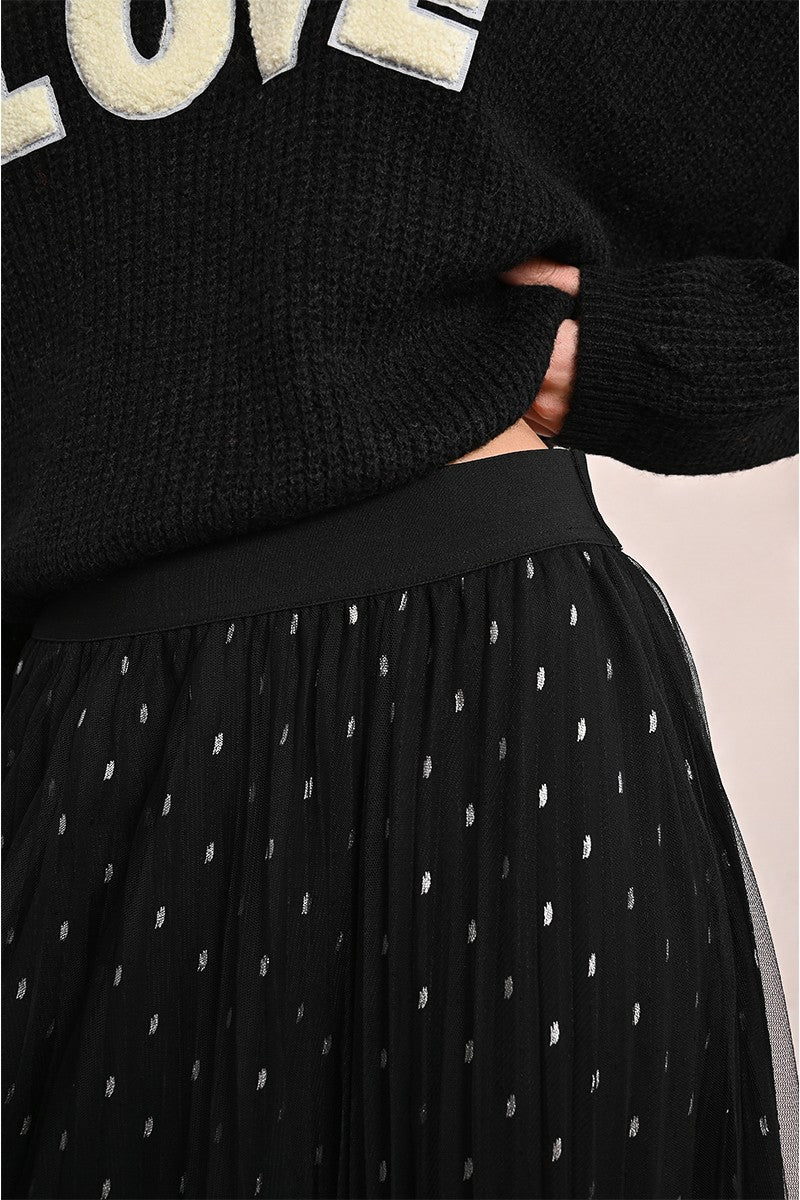 Close-up of Molly Bracken black tulle skirt with elastic waist and white polka dot detailing.