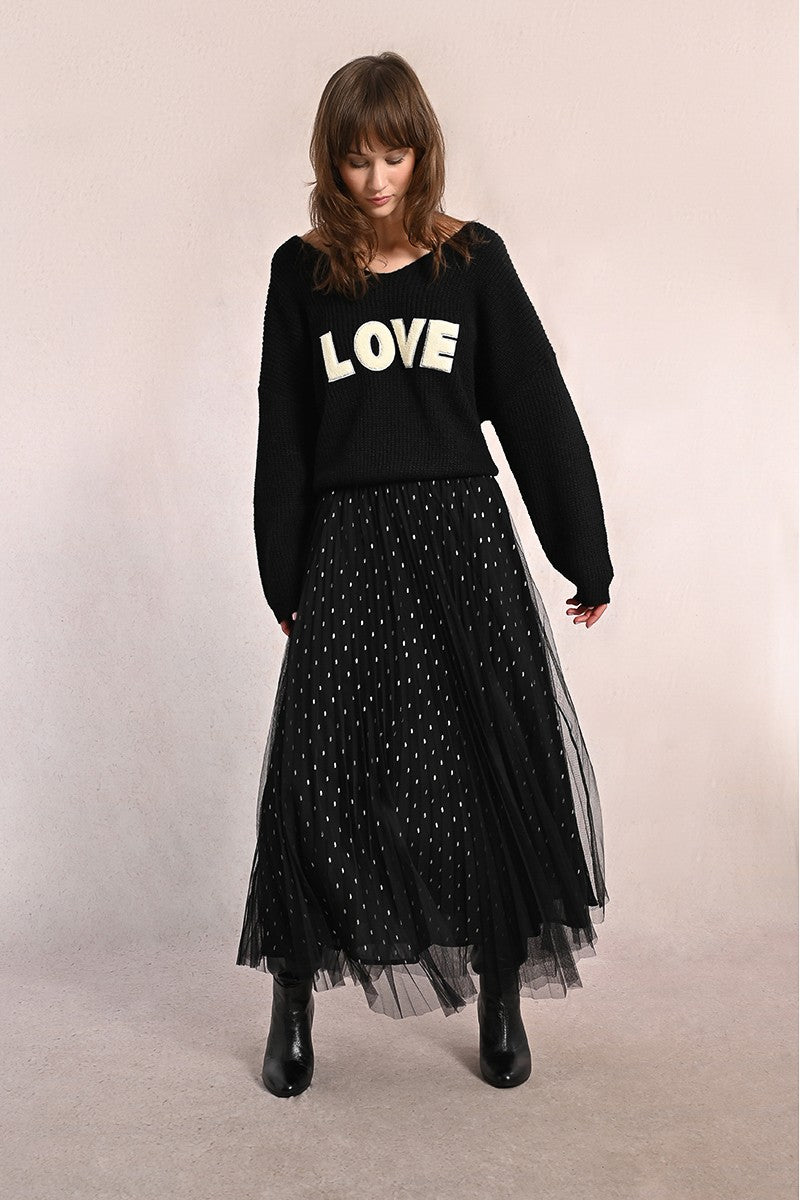 Model walking in Molly Bracken black tulle maxi skirt with pleats and polka dots.