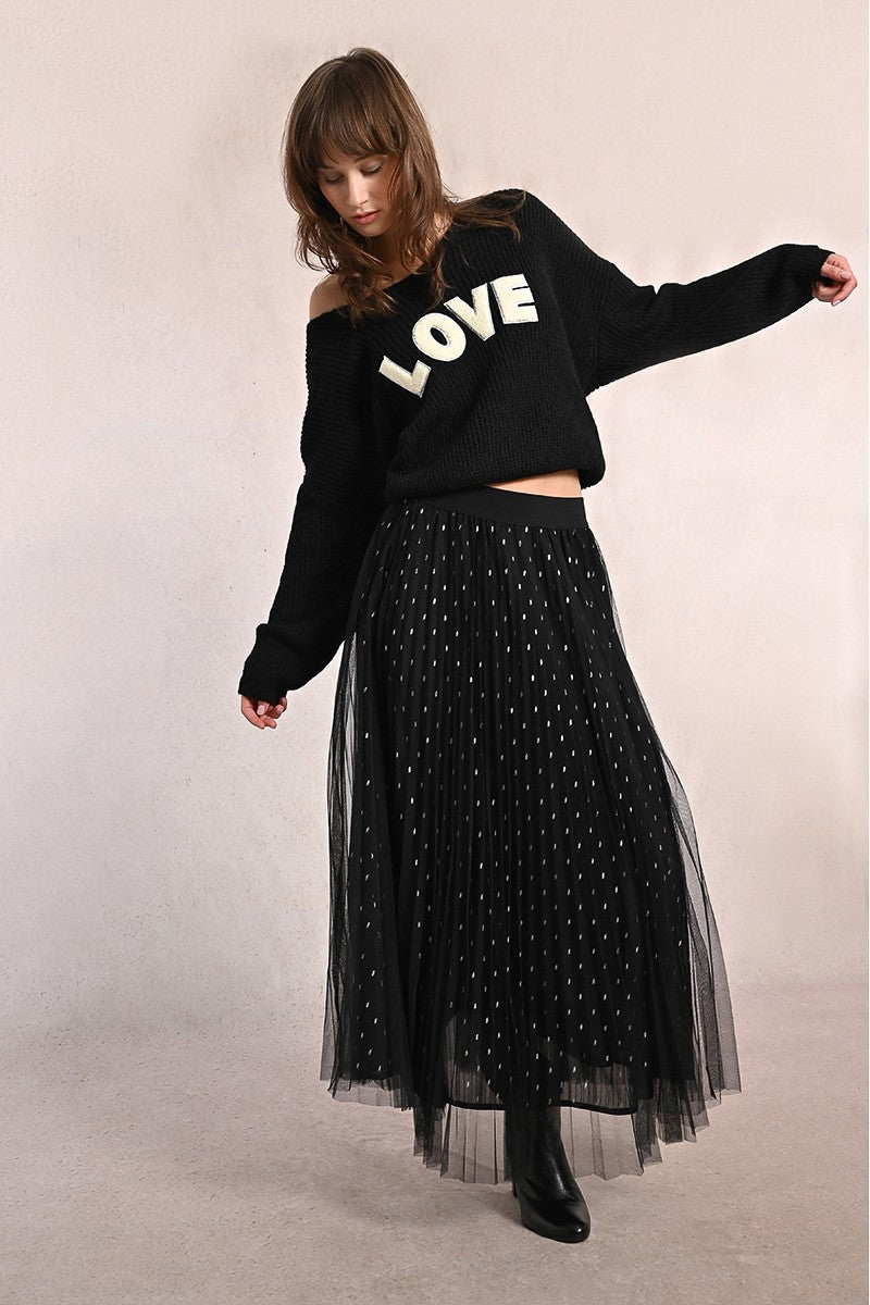 Model wearing Molly Bracken black pleated tulle maxi skirt with polka dots, styled with LOVE sweater for daytime.