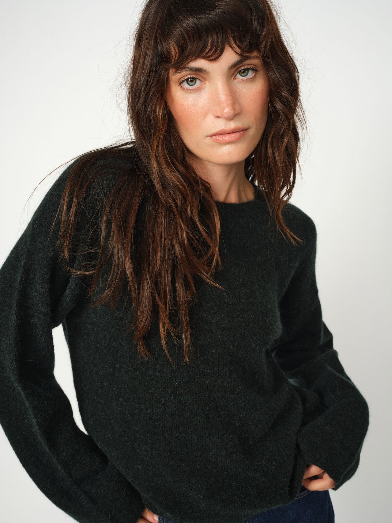 Model wearing Mos Mosh Mape O-neck green wool jumper with relaxed pose