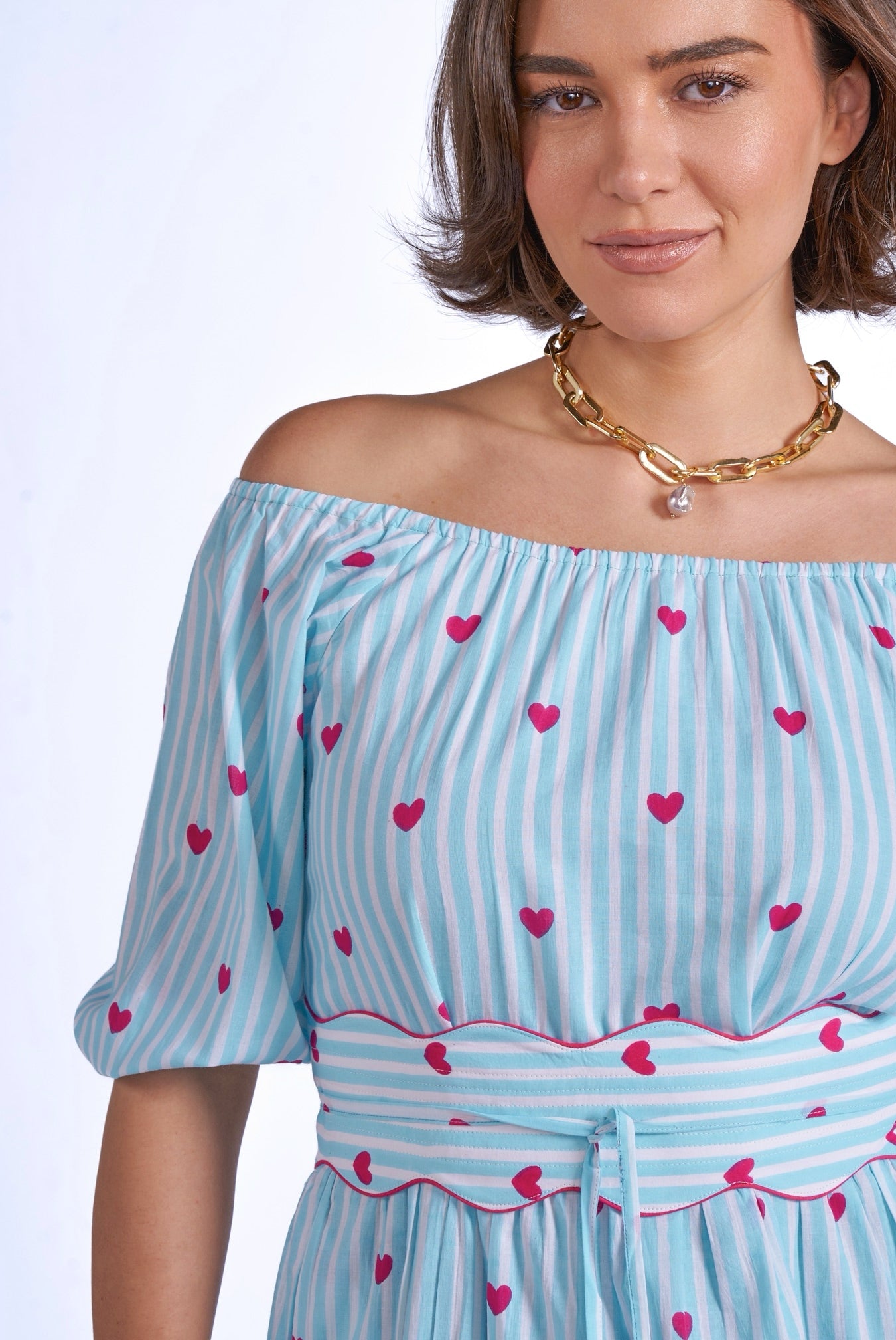 Close up blue stripe dress pink hearts waistband detail