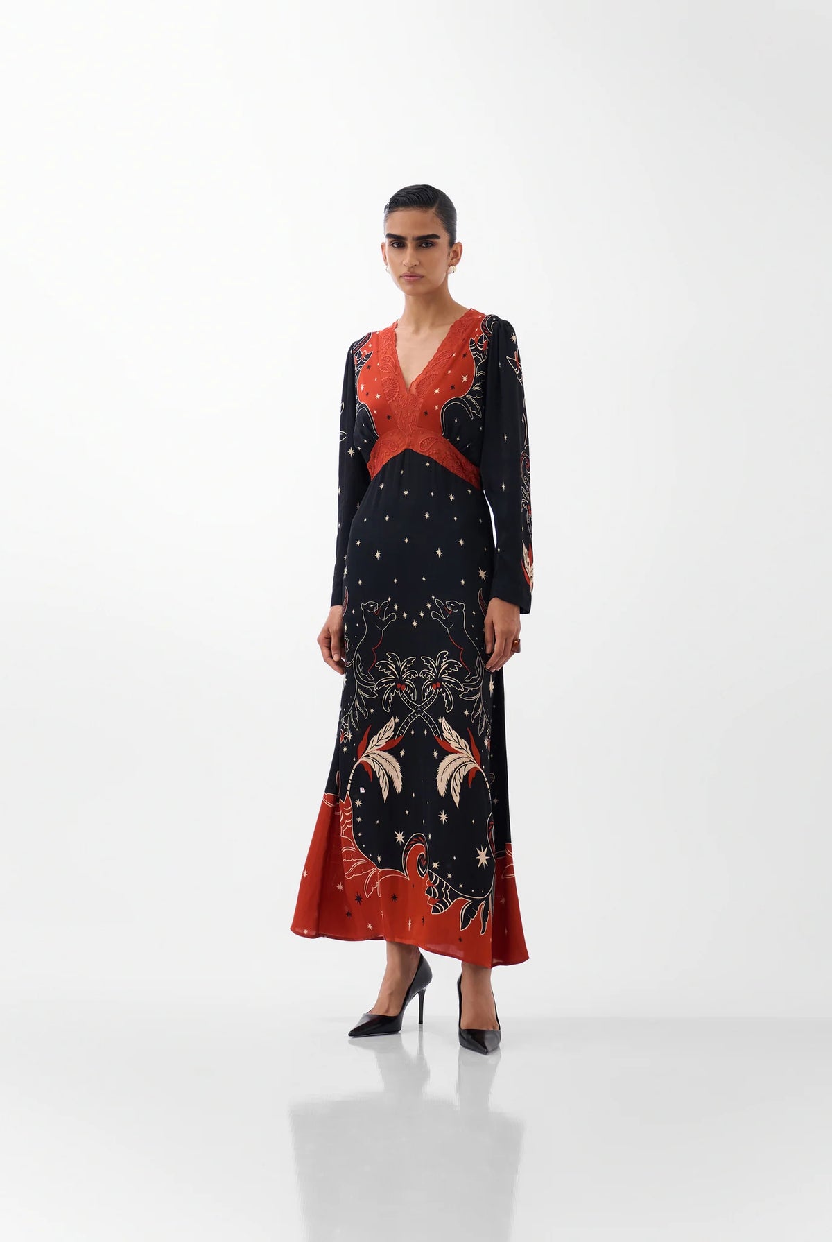 NOIB Aura Old Rose black maxi dress with orange-red botanical print and beaded V-neck – front model view.