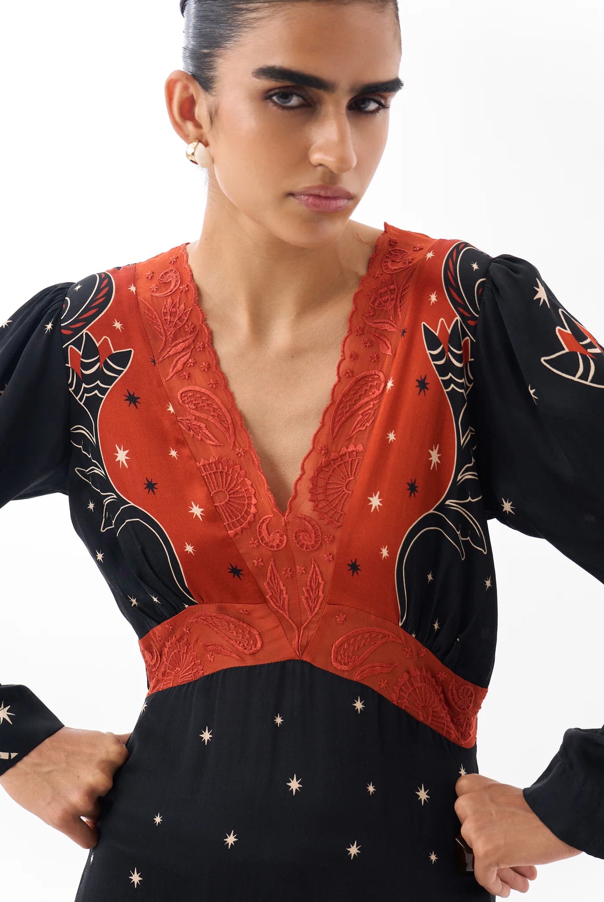 NOIB Aura black and orange-red maxi dress showing decorative V-neckline and hand-beaded detail – close-up.