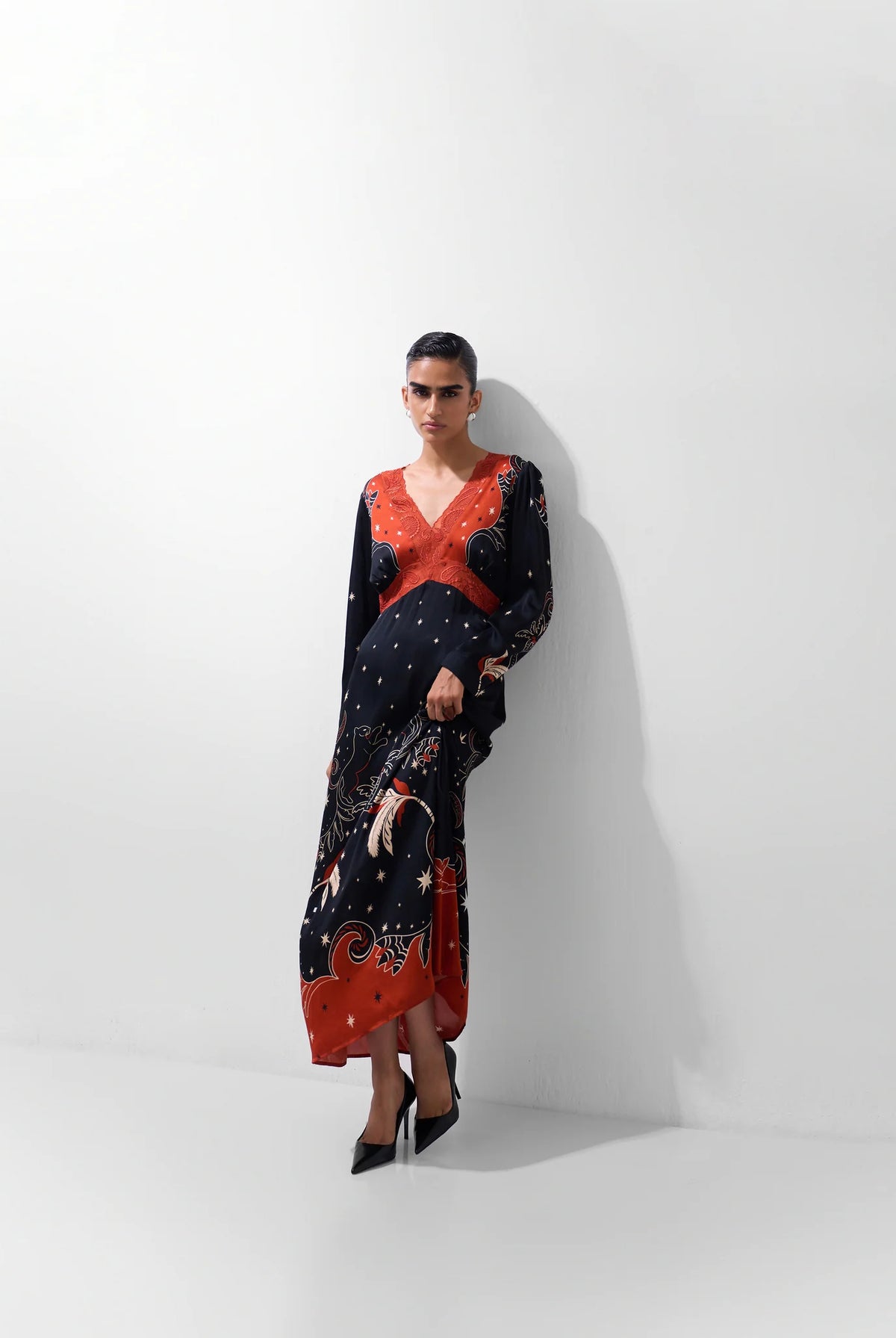NOIB Aura Old Rose botanical print maxi dress styled with black pointed heels – full model view.