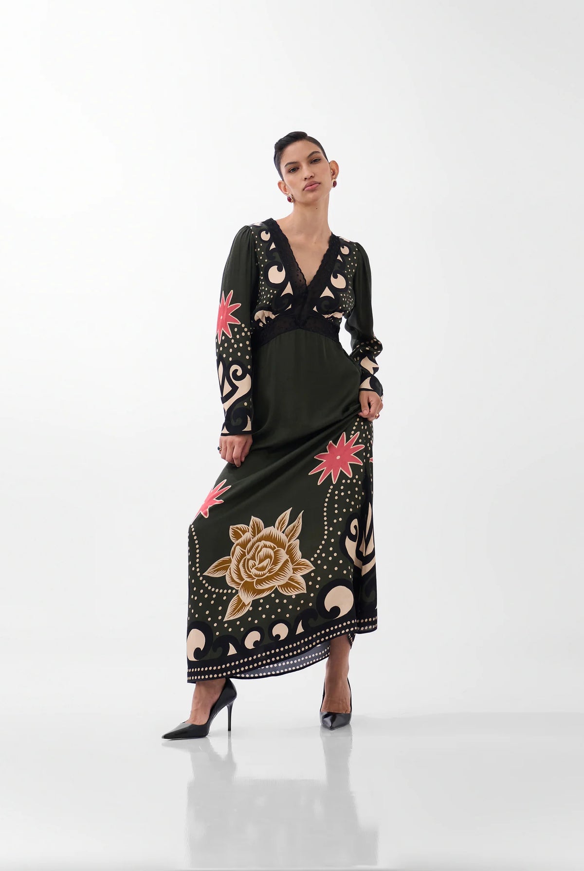NOIB Aura Nocturnal Jungle green printed maxi dress with long sleeves and decorative border print – angled front view.