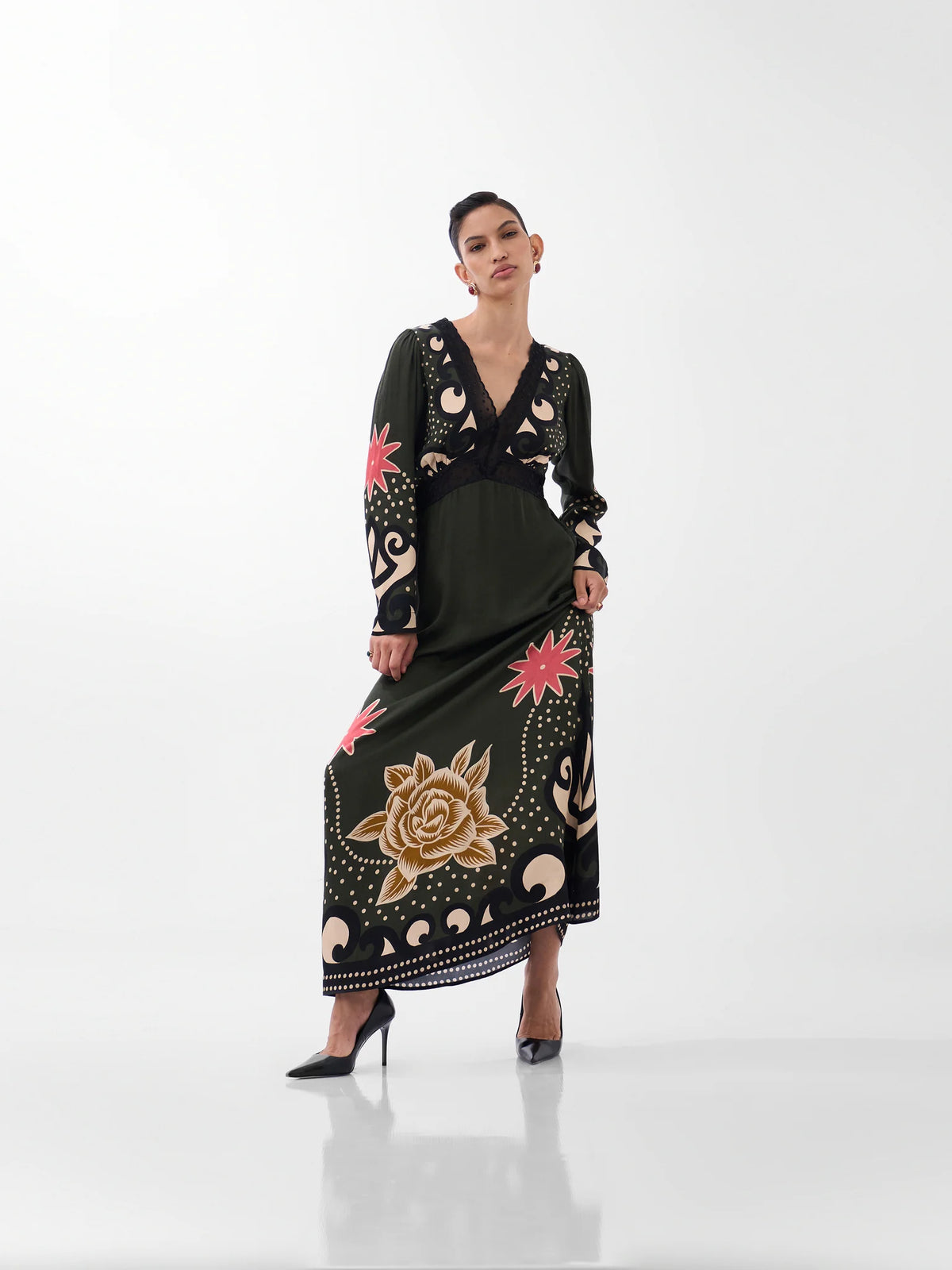 NOIB Aura Nocturnal Jungle green printed maxi dress with long sleeves and decorative border print – angled front view.