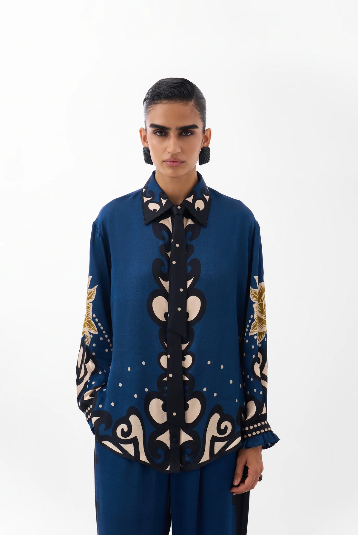 NOIB Iris Old Rose blue floral print shirt with ornate motifs, contrasting collar and front tie – front model view.