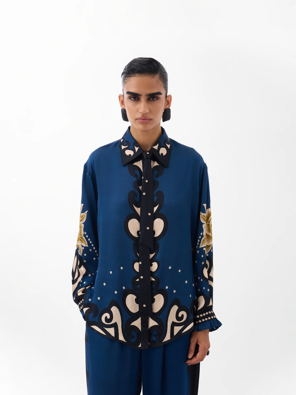 NOIB Iris Old Rose blue floral print shirt with ornate motifs, contrasting collar and front tie – front model view.