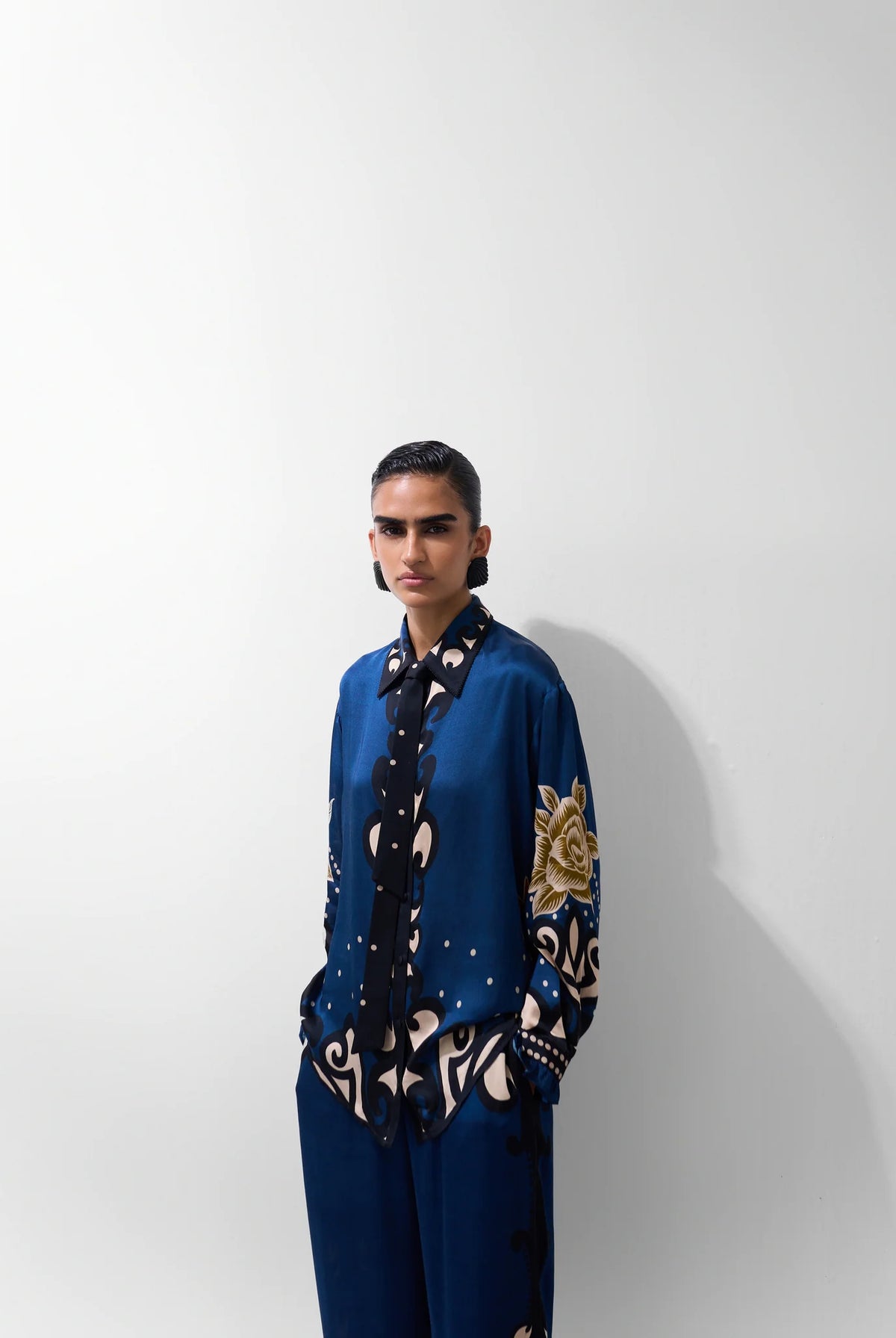 NOIB Iris blue floral print long sleeve shirt with contrasting dark trim – three-quarter model view.