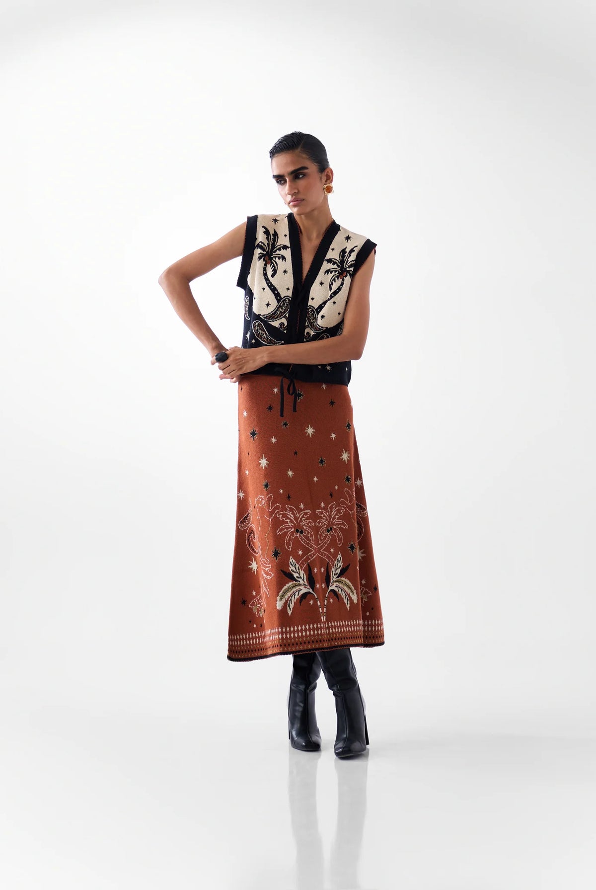 NOIB Lola jacquard knitted waistcoat styled with coordinating rust-coloured Lola midi skirt – full model view.