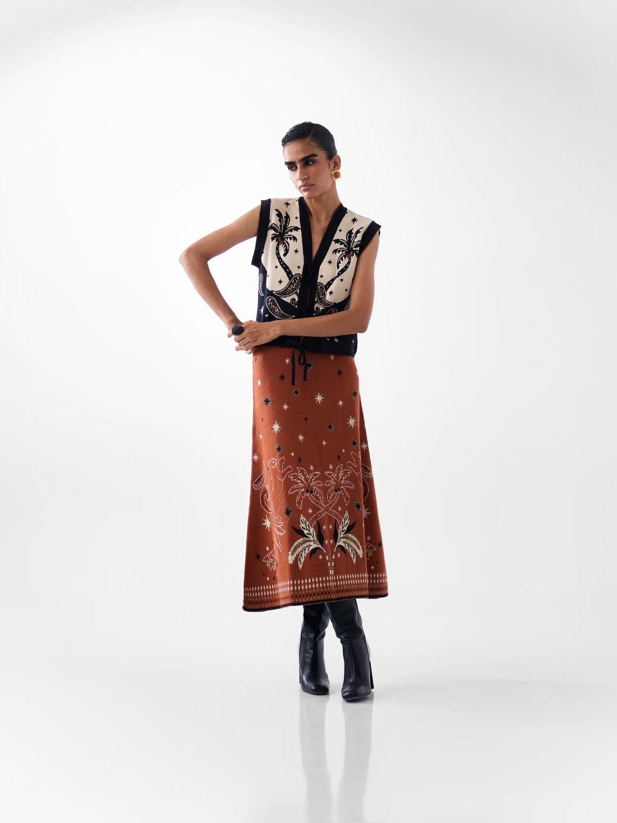NOIB Lola jacquard knitted waistcoat styled with coordinating rust-coloured Lola midi skirt – full model view.