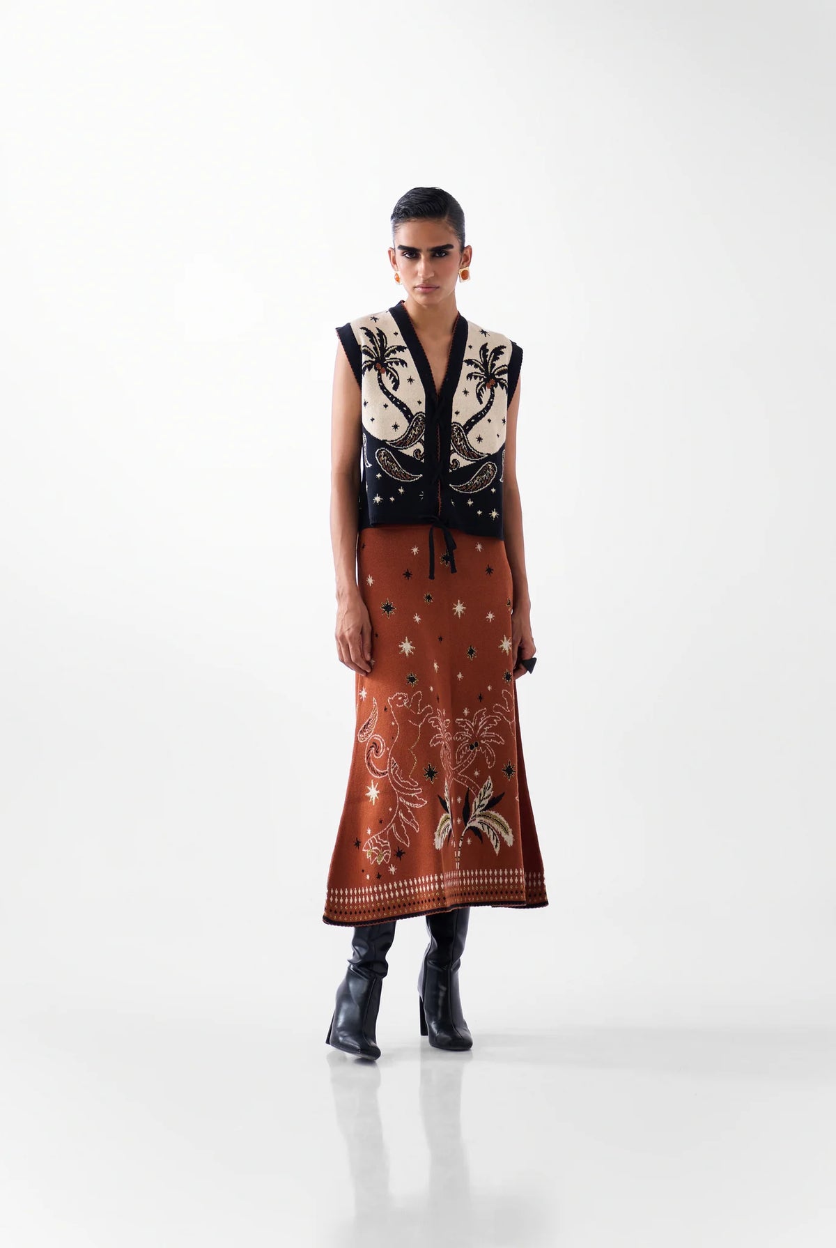 NOIB Lola Nocturnal Jungle tie-front knitted waistcoat worn with matching patterned skirt and boots – front outfit view.