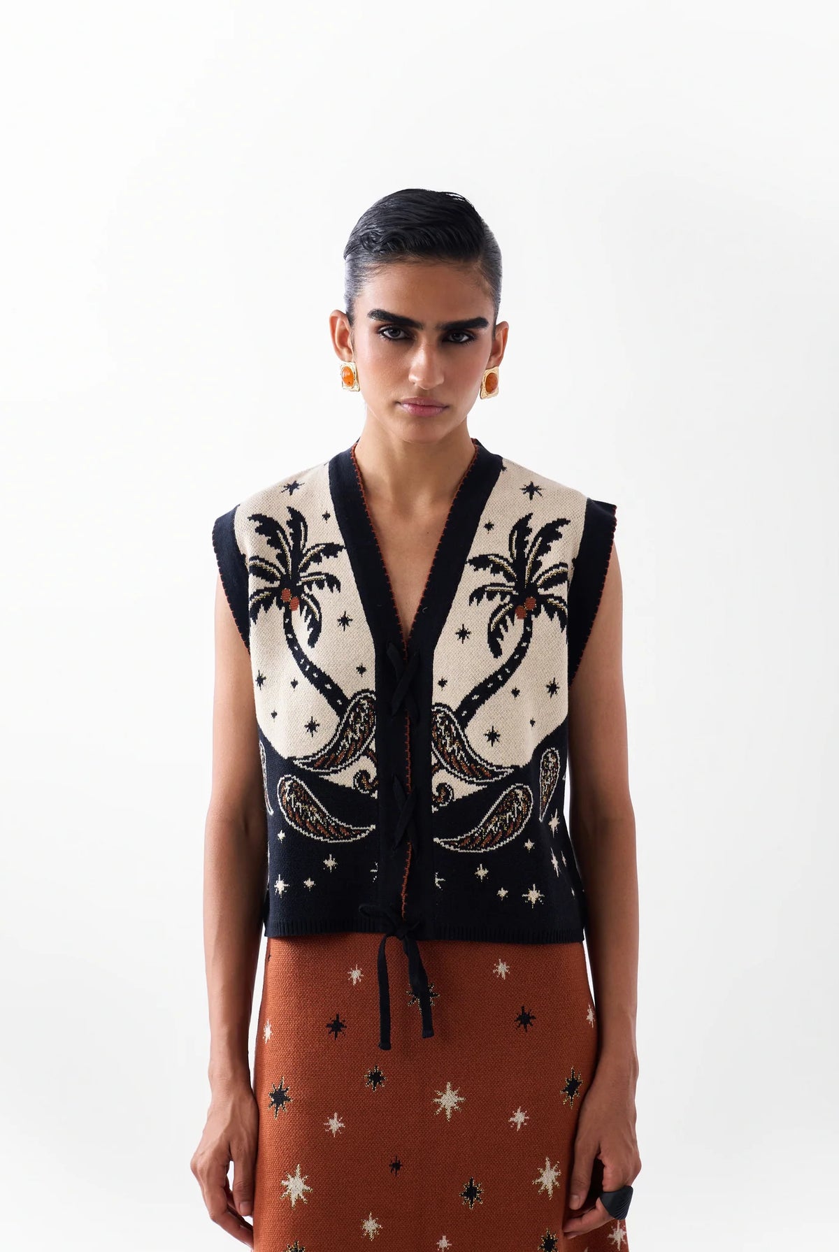 NOIB Lola Nocturnal Jungle black and ivory jacquard knitted waistcoat with palm tree motifs – front model view.