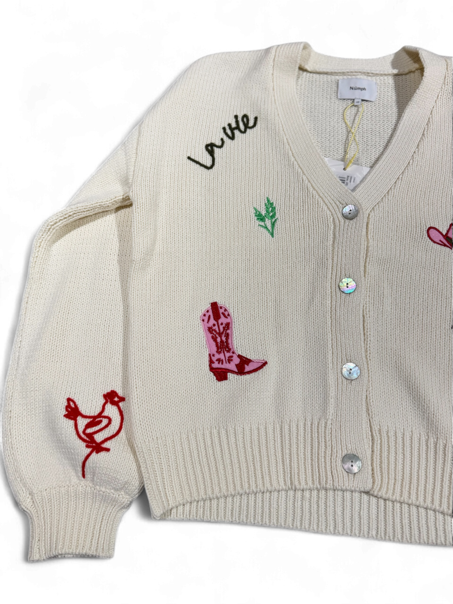 Side view of Numph Nuwally cardigan with red bird and cowboy boot motifs on sleeve