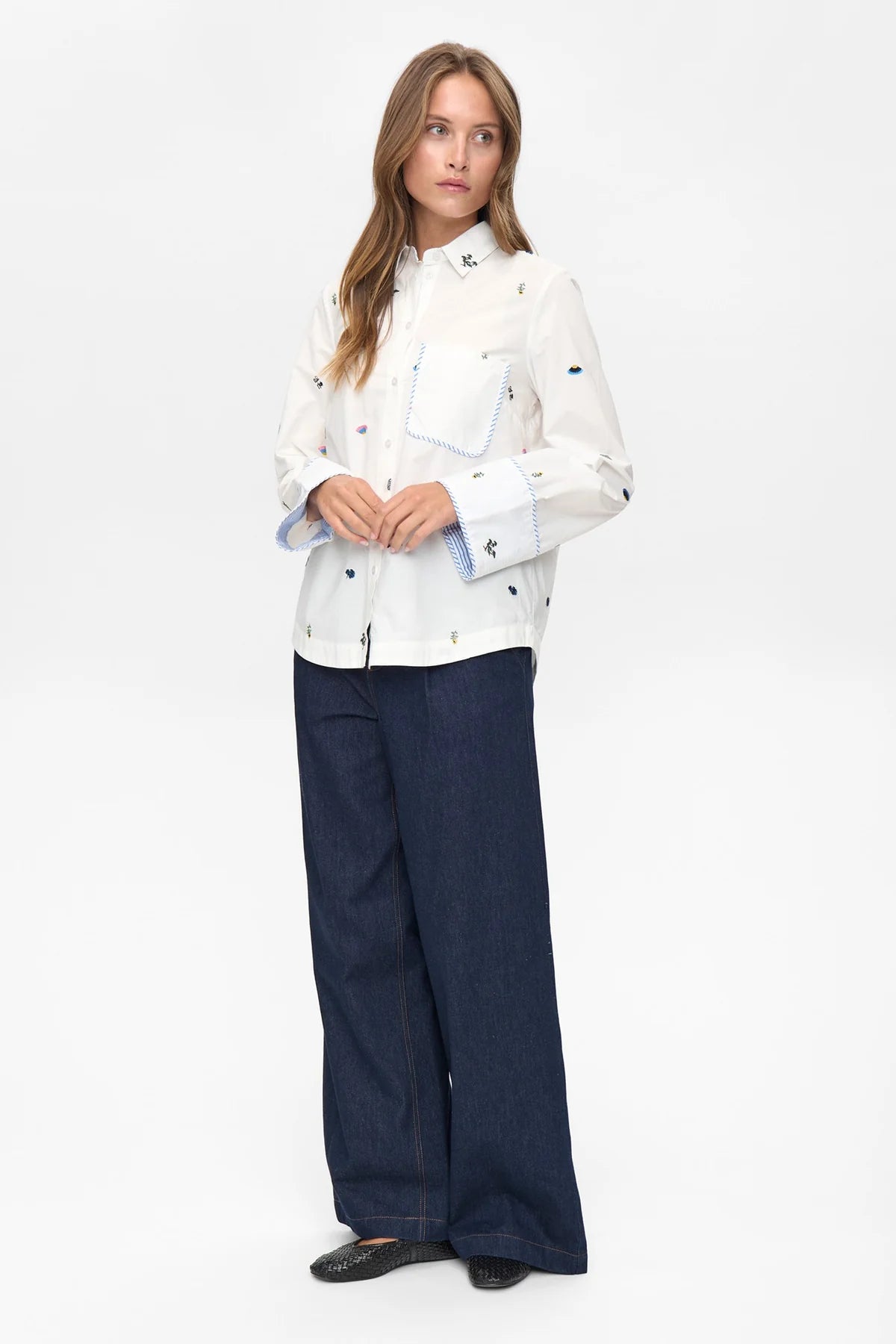 Numph Nuchiro shirt wide cuffs with blue trim and floral embroidery.