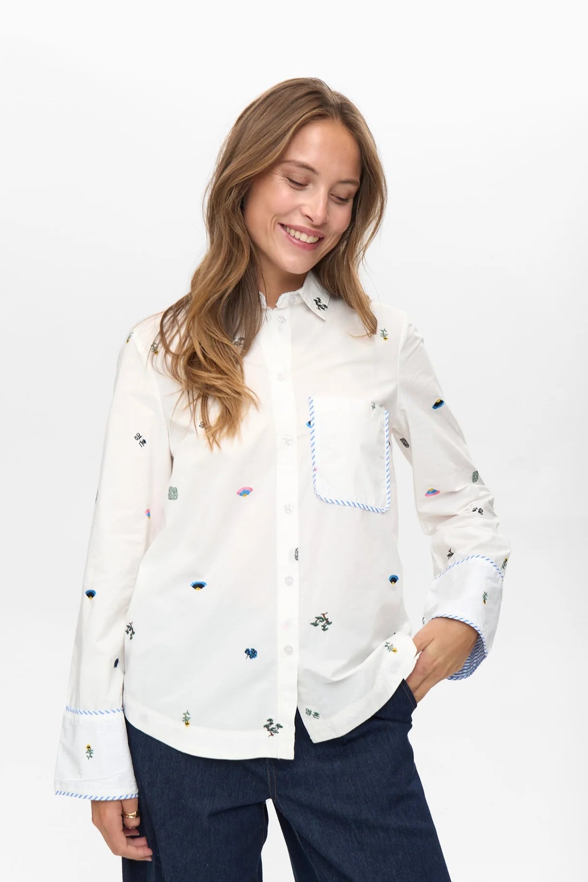 Numph Nuchiro white embroidered cotton shirt styled with dark denim jeans