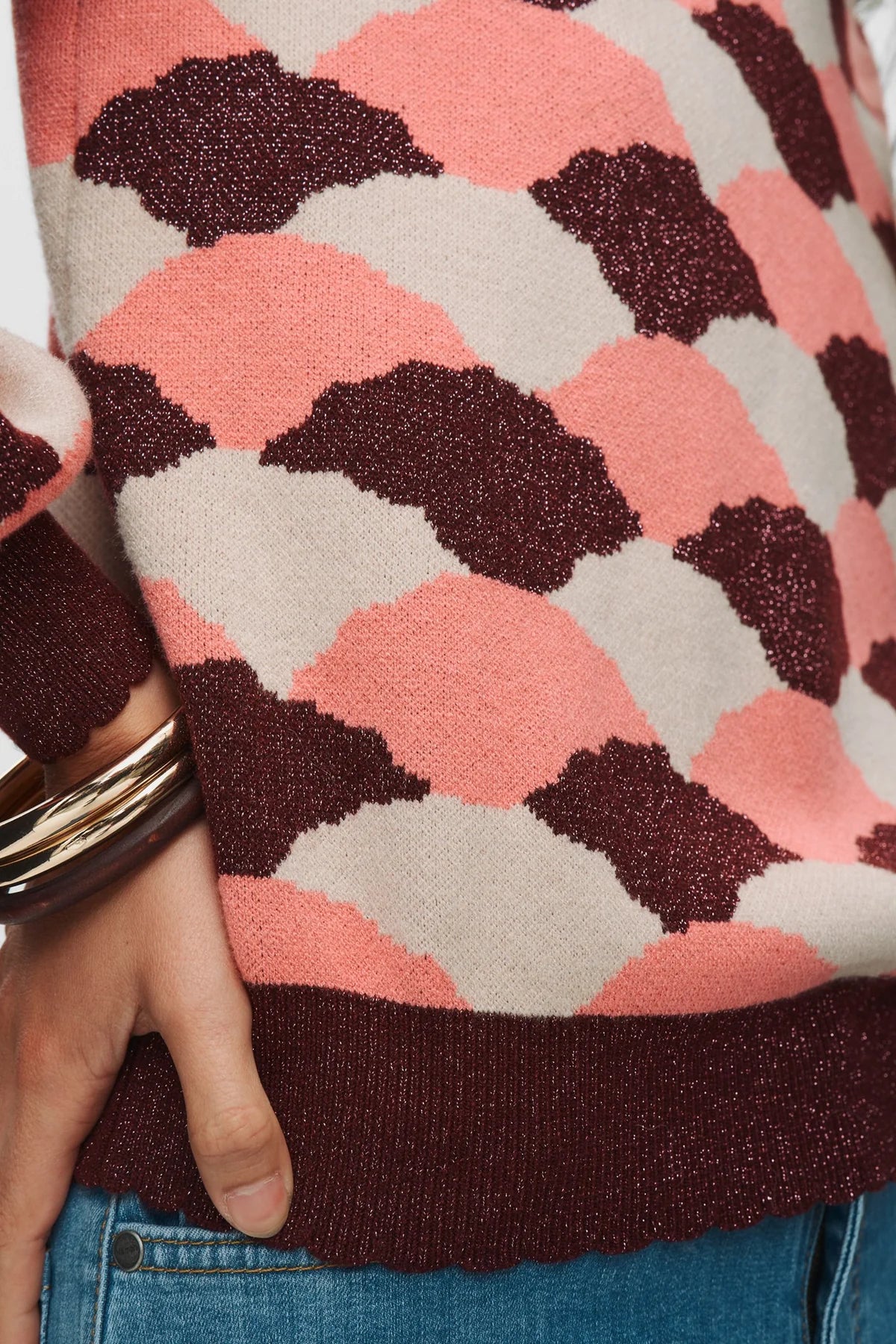 Close-up of Numph Nulila metallic thread detail in geometric pink and burgandy knit jumper for women