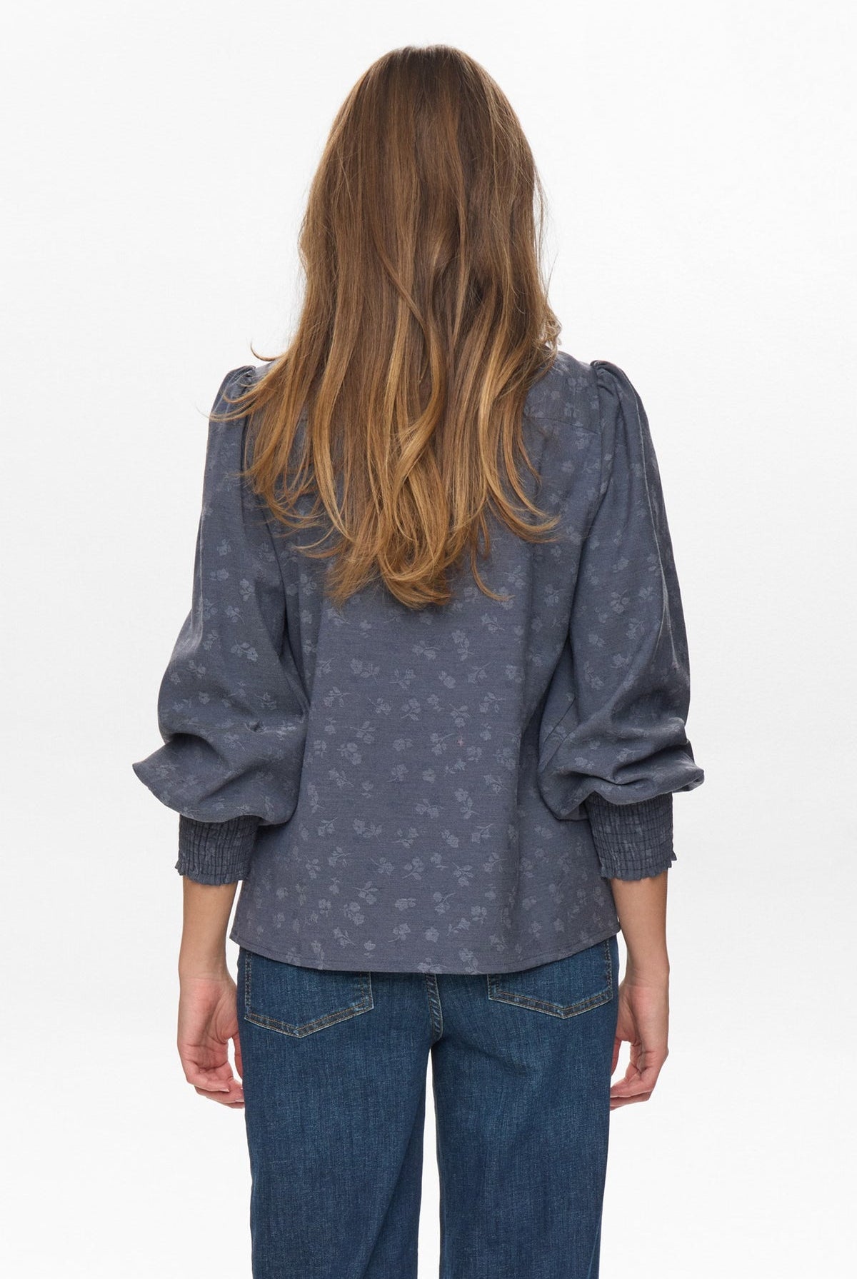 Back view of Numph Nucila Denim Blue Shirt – puffed sleeves and smocked cuffs