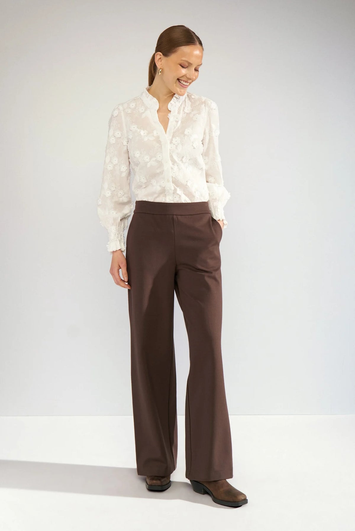 Nümph Nulenea white embroidered blouse styled with brown tailored trousers – full outfit view