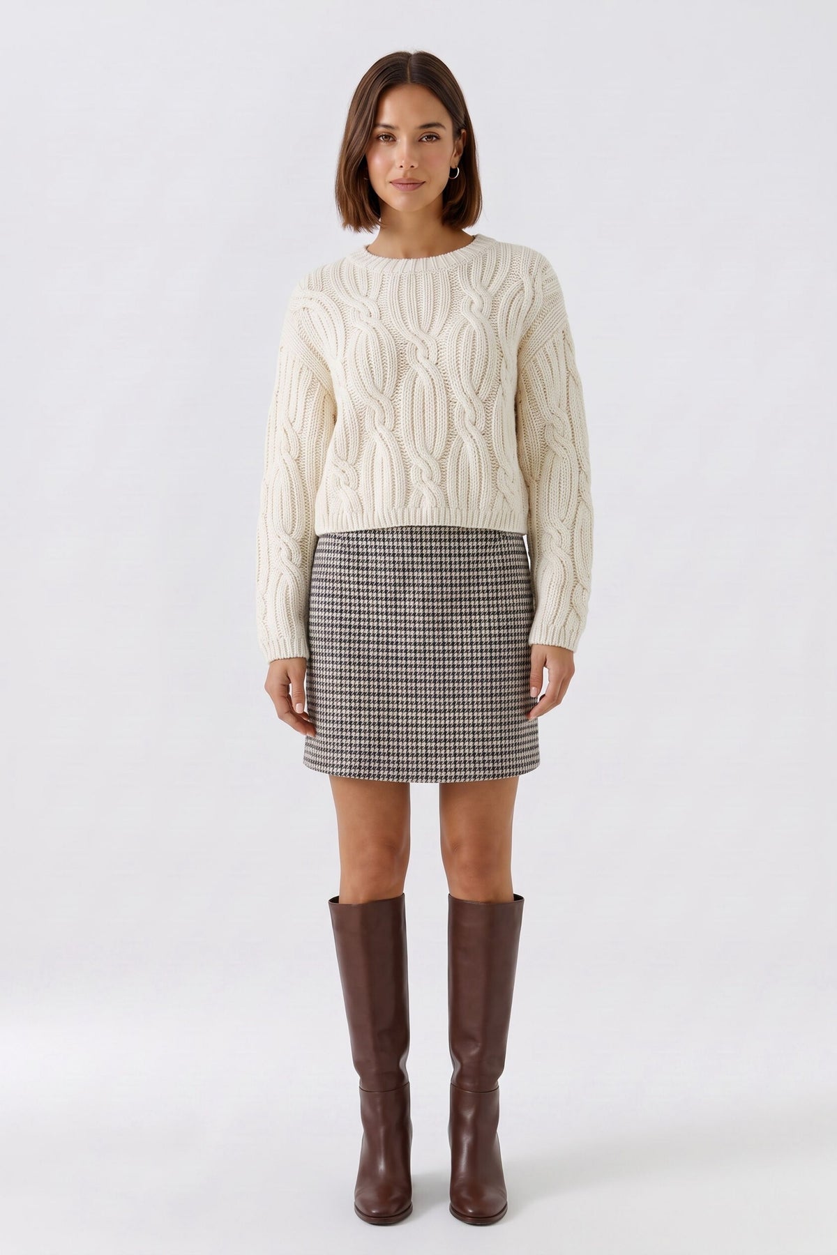 Oui brown houndstooth mini skirt styled with cream knit and knee-high boots – outfit view